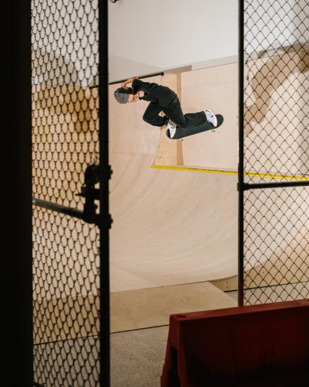 Ein Skateboarder macht einen Trick in einer Halfpipe.