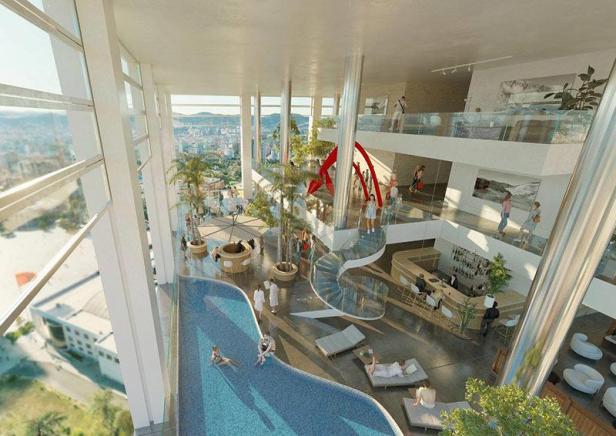 Innenansicht des Shigeru Ban Multifunktionsturms in Tirana mit Pool und Bar.