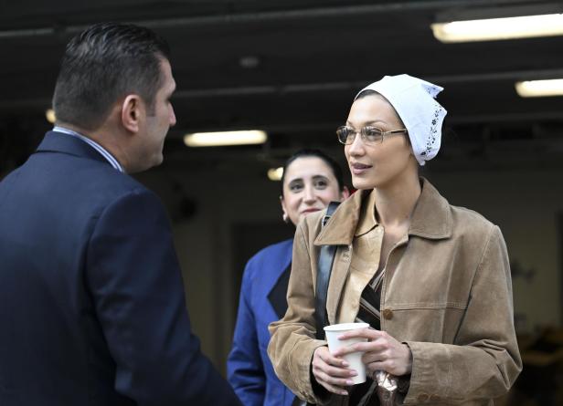Bella Hadid mit weißem Kopftuch und goldener Brille.