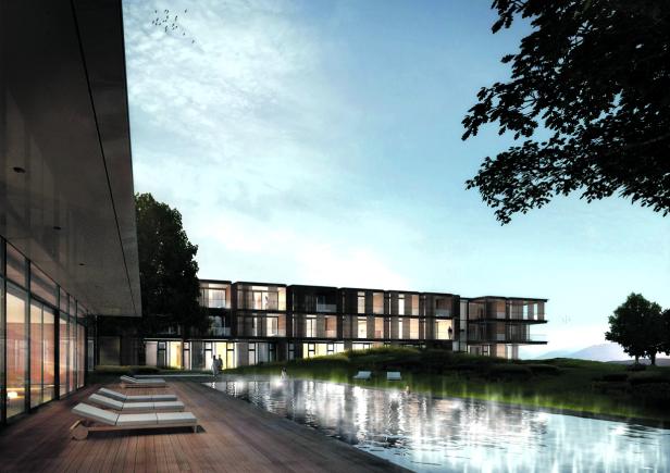 Ein modernes Hotel mit Pool und Liegestühlen an einem bewölkten Tag.