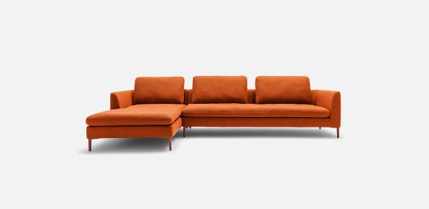 Ein orangefarbenes Ecksofa mit drei Rückenkissen steht vor einem weißen Hintergrund.