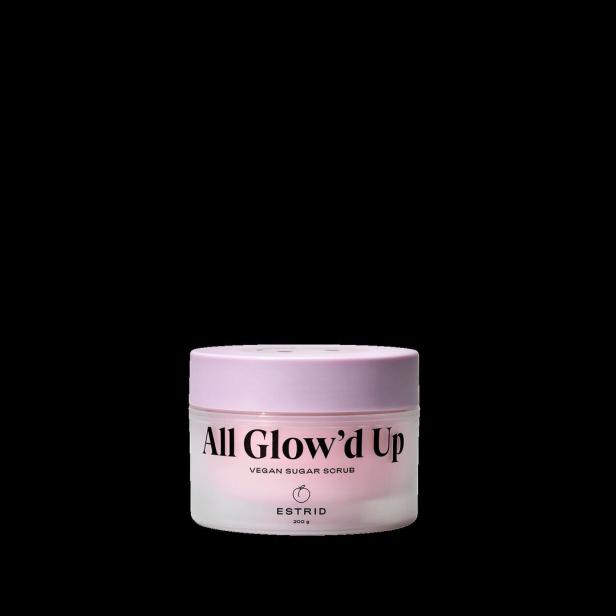 Ein Tiegel „All Glow’d Up“ veganes Zuckerpeeling von Estrid vor schwarzem Hintergrund.