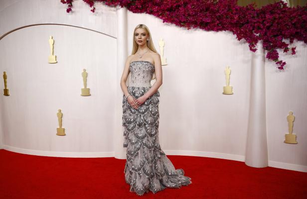 Anya Taylor-Joy in einem silbernen Kleid auf dem roten Teppich.