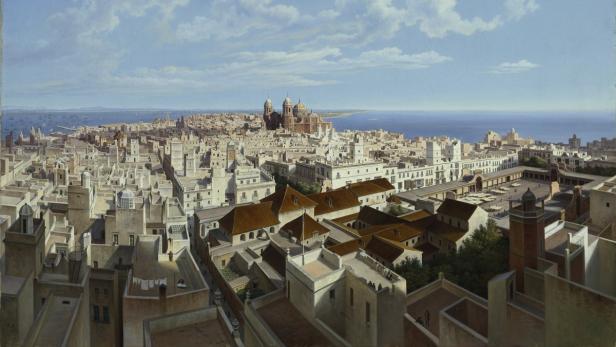 Ein Panoramablick über eine Küstenstadt mit einer großen Kathedrale im Hintergrund.