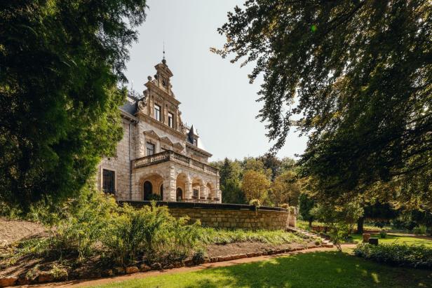 Schloss in grünem Garten.