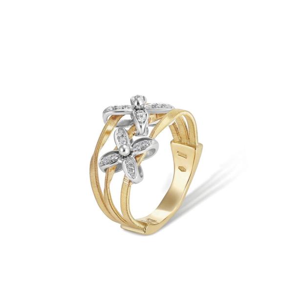 Ein goldener Ring mit zwei silbernen Blumen, die mit Diamanten besetzt sind.