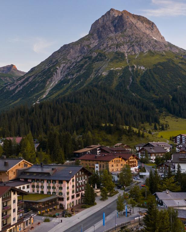 Der Gasthof Post in Lech vor einer beeindruckenden Bergkulisse.