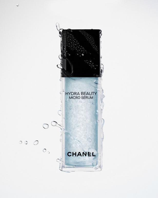 Eine Flasche Chanel Hydra Beauty Micro Sérum mit Wassertropfen.