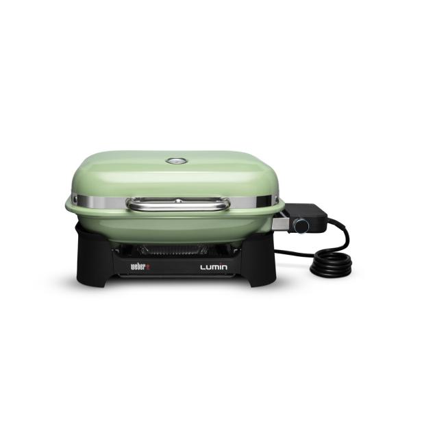Ein grüner Weber Lumin Elektrogrill steht auf einem Tisch.