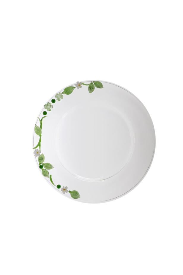 Ein weißer Teller mit einem floralen Dekor aus Blättern und kleinen Blüten.