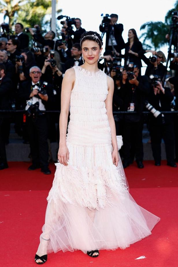 Margaret Qualley auf dem roten Teppich in einem weißen Kleid.