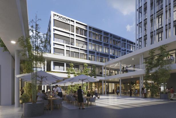 Urbanes Viertel mit Bürogebäuden und einem grünen Innenhof mit Restaurants und Sonnenschirmen