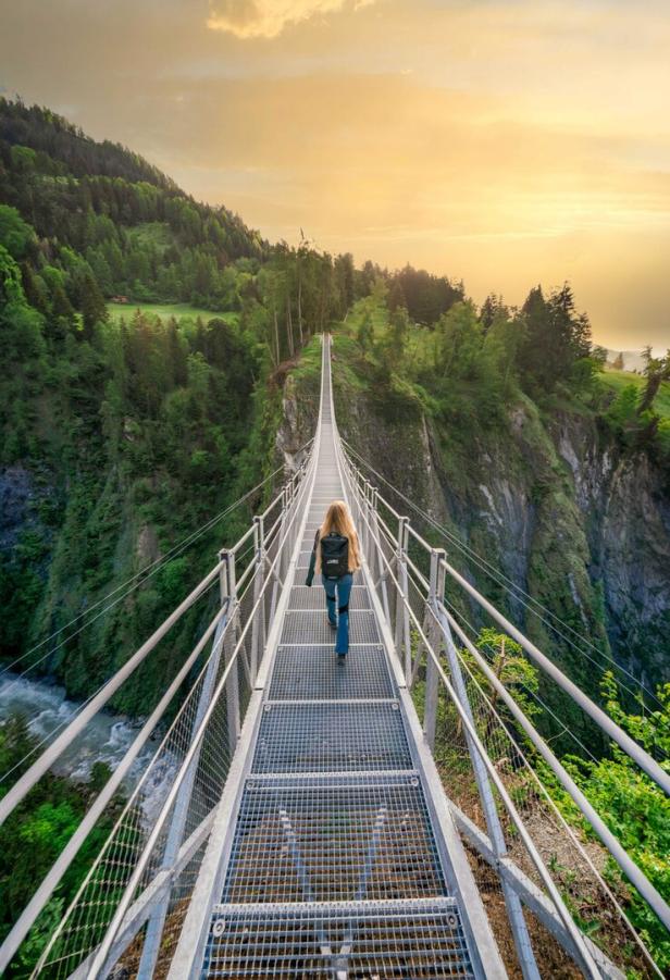 Frau geht über eine Hängebrücke über der Inselschlucht Prägraten und Virgen in Osttirol
