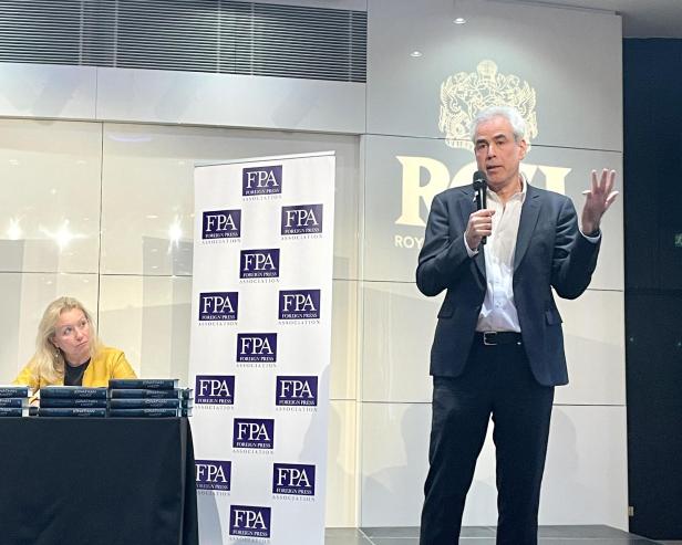 Ein Mann spricht auf einer Bühne vor einem Banner der Foreign Press Association.