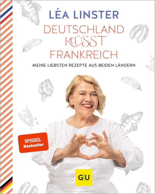 Das Cover des Buches „Deutschland küsst Frankreich“ von Léa Linster mit der Autorin, die ein Herz formt.
