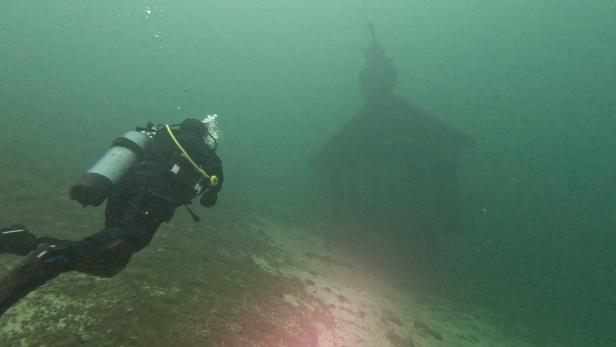 Unterwsseraufnahme von Taucher im Attersee, beim Pfahlbauhaus