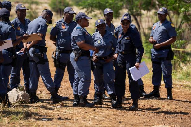 Police stand guard at the entrance to the mineshaft in a standoff between them and illegal gold miners in Stilfontein