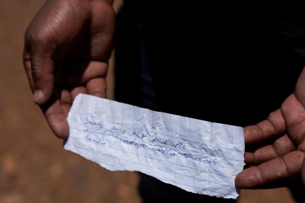 A volunteer in a rescue operation to bring miners to the surface in a standoff between the police and illegal gold miners shows a note written in the Xhosa language in Stilfontein