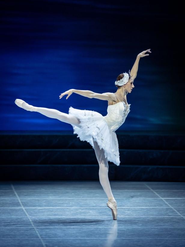 Die Prima Ballerina des Balletts Schwanensee steht mit einem Fuß auf ihren Zehenspitzen.
