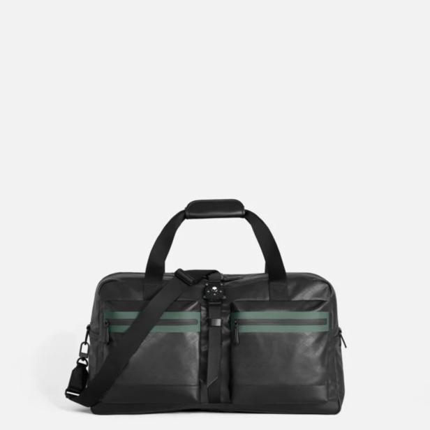 Eine schwarze Reisetasche mit grünen Streifen und einem Schultergurt vor einem weißen Hintergrund.