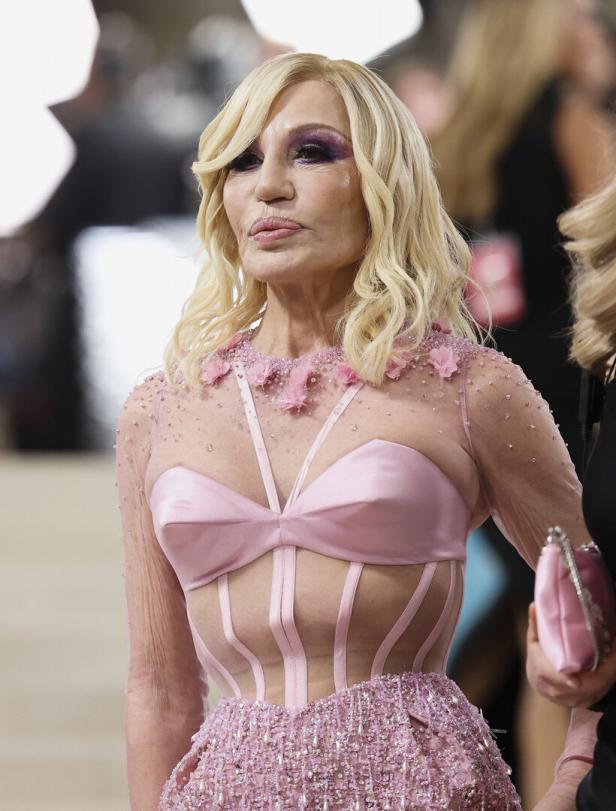 Donatella Versace in einem rosa Kleid mit transparenten Details.