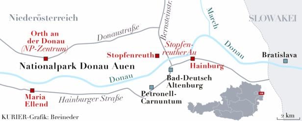 Eine Karte des Nationalparks Donau-Auen mit Flüssen, Straßen und Ortschaften wie Bratislava und Hainburg.