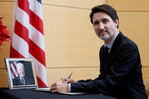 FILE PHOTO: Canada's Prime Minister Justin Trudeau signs a book of condolences marking the passing of former U.S. President Jimmy Carter at the U.S. Embassy in Ottawa