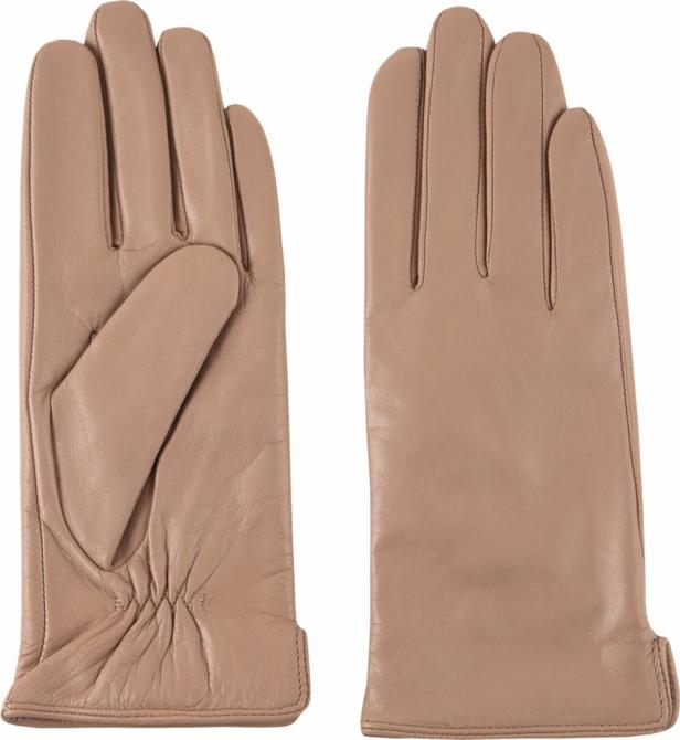 Ein Paar beigefarbene Lederhandschuhe liegen nebeneinander.