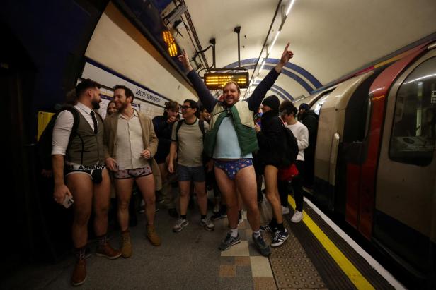 People travel on the London Underground during the "No Trousers Tube Ride" in London