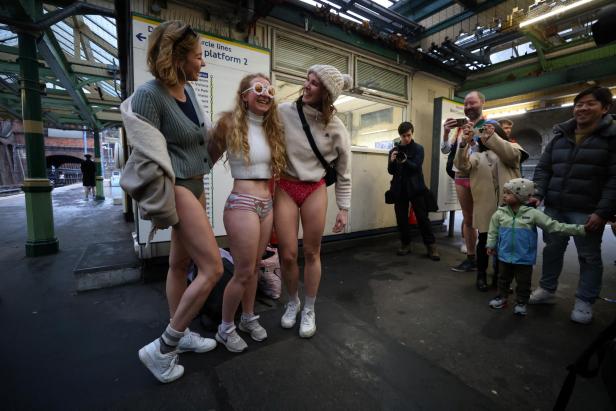 People travel on the London Underground during the "No Trousers Tube Ride" in London