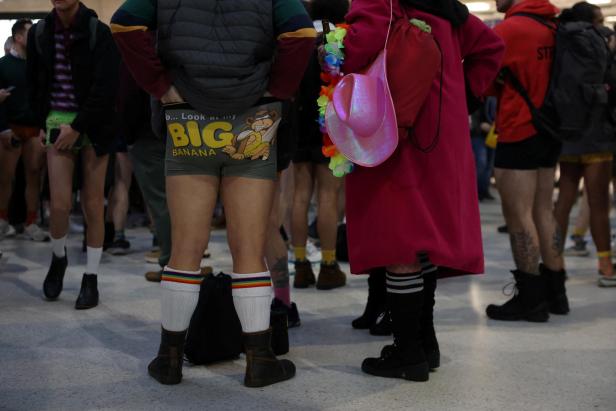 People travel on the London Underground during the "No Trousers Tube Ride" in London