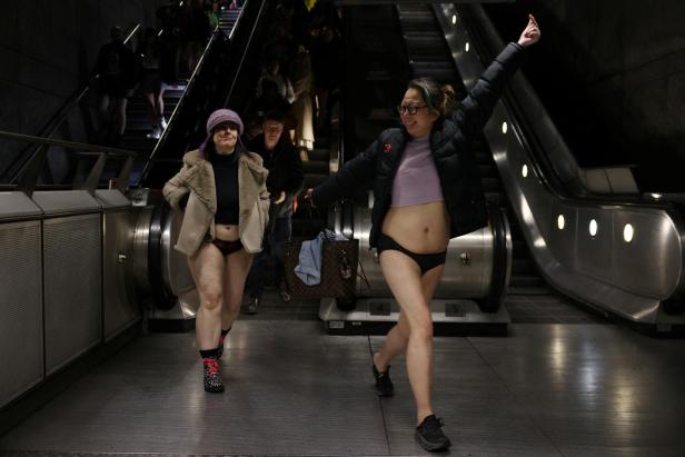 People travel on the London Underground during the "No Trousers Tube Ride" in London