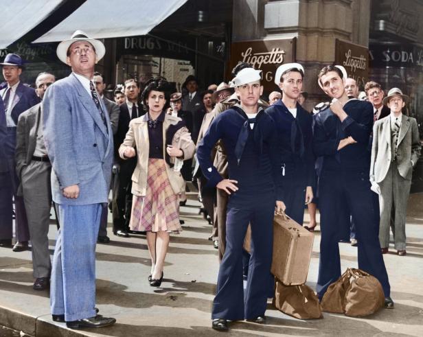 Matrosen der US-Marine in Uniform mit Kappen inmitten von Zivilisten am Times Square anlässlich des D-Days 1944.