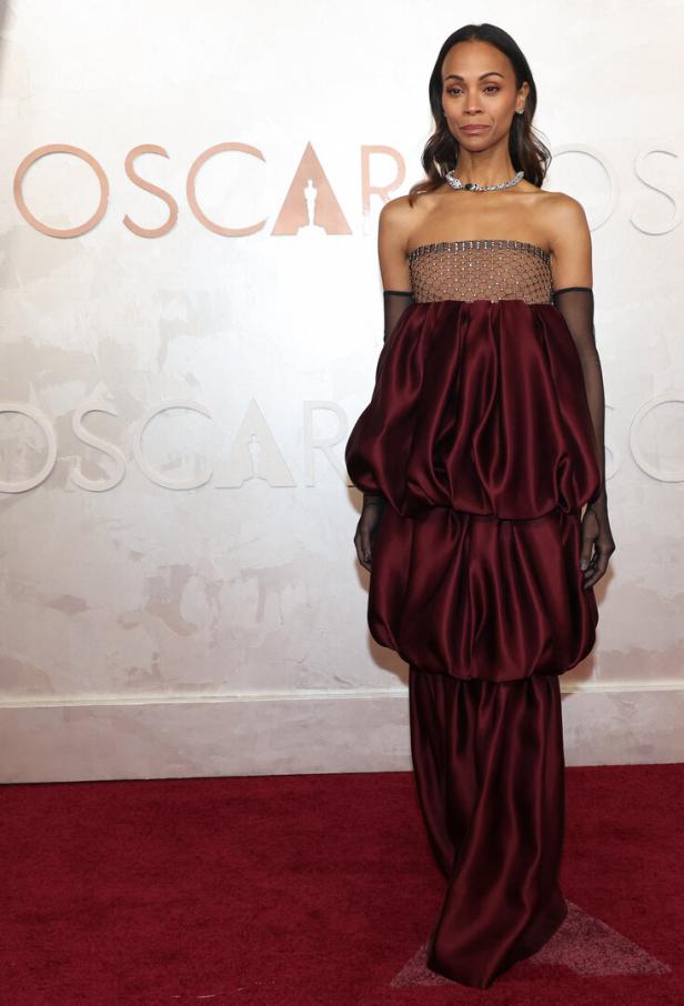 Zoe Saldana in einem burgunderroten Kleid bei den Oscars.