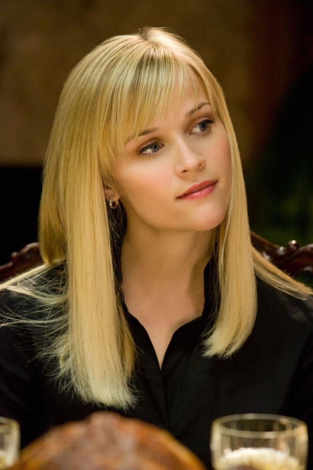 Reese Witherspoon mit blonden Haaren und schwarzem Oberteil.