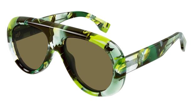 Eine Gucci-Sonnenbrille mit braunen Gläsern und einem grün-schwarz gemusterten Rahmen.
