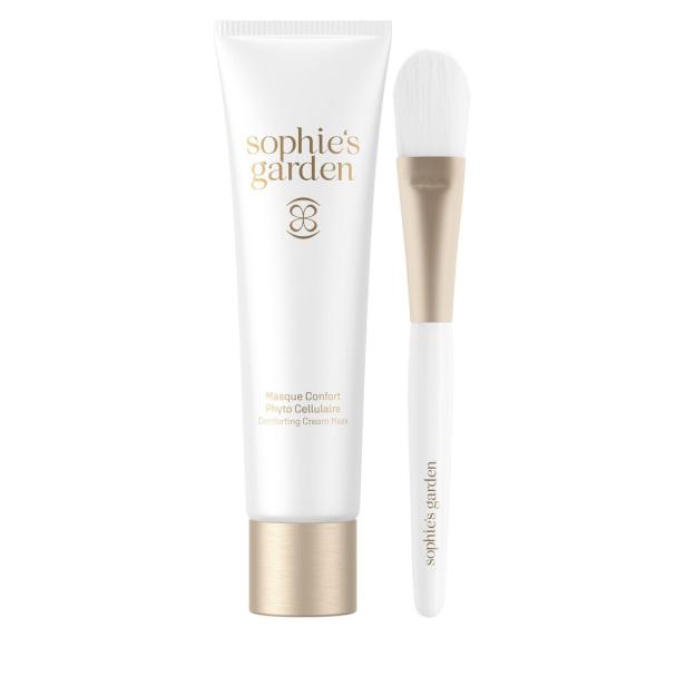 Eine Tube „Sophie's Garden“ Gesichtsmaske und ein Pinsel liegen nebeneinander.