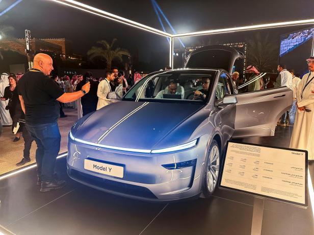FILE PHOTO: A guest takes photos of Tesla Model Y, displayed during the inauguration ceremony of first Tesla showroom, in Riyadh FILE PHOTO: A guest takes photos of Tesla Model Y, displayed during the inauguration ceremony of first Tesla showroom, in Riyadh
