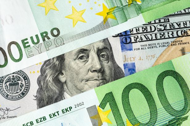 Franklin from a 100 US dollar banknote looks out between two 100 euro banknotes. The relationship between Europe and America, America's influence on the European Union concept Franklin from a 100 US dollar banknote looks out between two 100 euro banknotes. The relationship between Europe and America, America's influence on the European Union concept