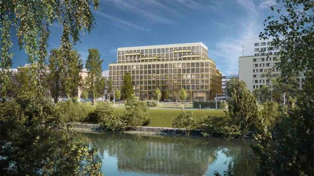Das Leopoldsquartier Bürogebäude, gesehen von einem Flussufer.