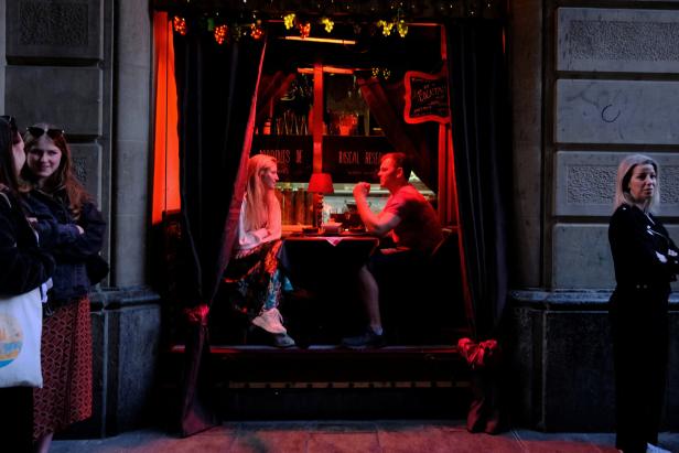 Tourists take a lunch as others wait to enter at the bar in Barrio Gotico (Gothic Quarter) in Barcelona Tourists take a lunch as others wait to enter at the bar in Barrio Gotico (Gothic Quarter) in Barcelona