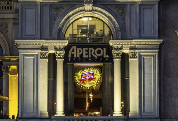 Die Fassade der Aperol Terrazza mit einer leuchtenden Aperol Spritz-Werbung.