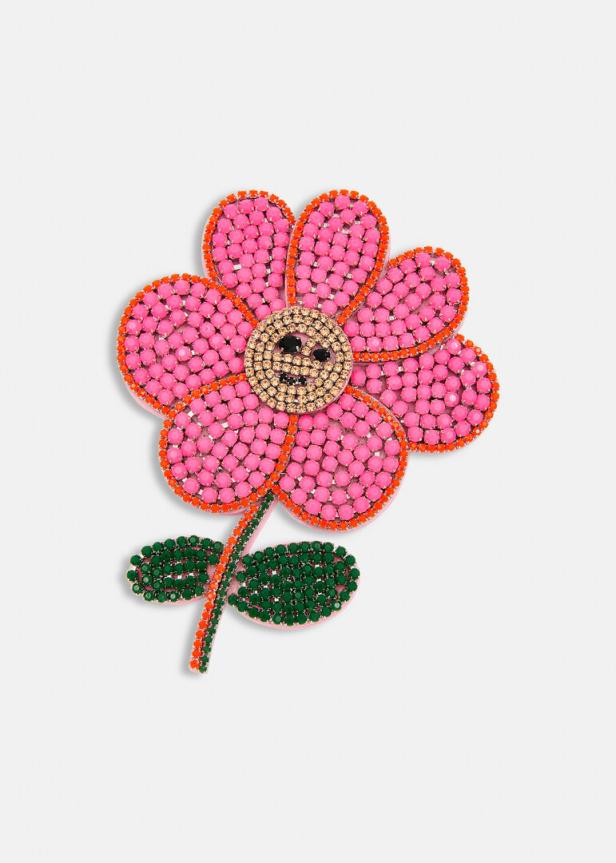 Eine stilisierte, pinkfarbene Blume mit einem Gesicht in der Mitte.