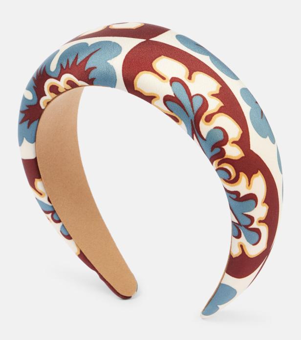 Ein gepolstertes Haarband mit einem floralen Muster in Blau und Rot.