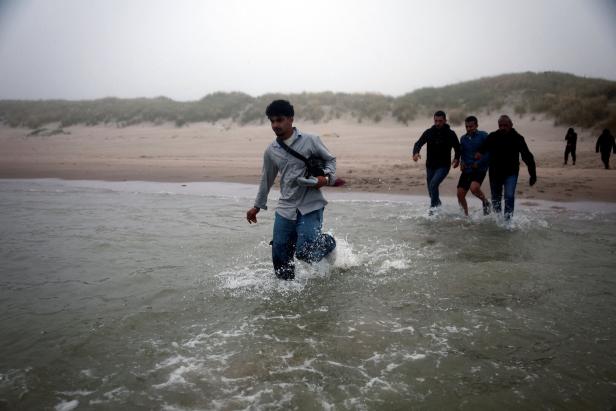 FILE PHOTO: Migrant dinghy heads off the French coast to cross the English channel