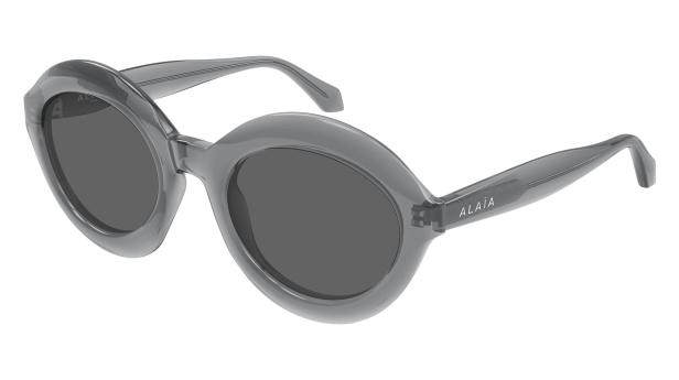 Graue „Alaïa“-Sonnenbrille mit ovalen Gläsern.