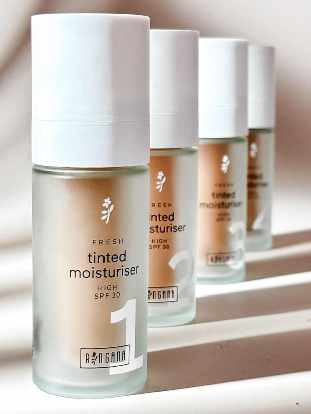 Vier Flaschen „Fresh Tinted Moisturiser“ von Ringana mit Lichtschutzfaktor 30 stehen in einer Reihe.