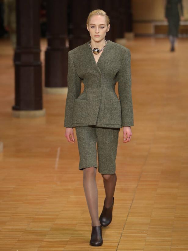 Ein Model läuft auf dem Laufsteg in einem Tweed-Blazer und Shorts von Véronique Leroy.