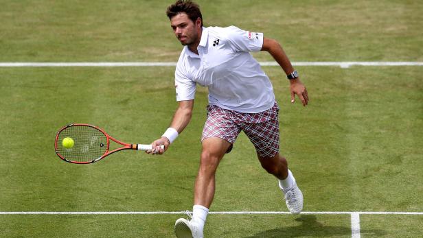 Stan Wawrinka schlägt einen Tennisball auf einem Rasenplatz.