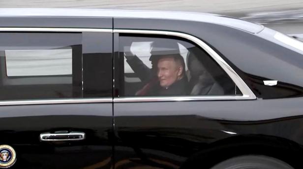 Putin and Trump share a laugh en route to meeting